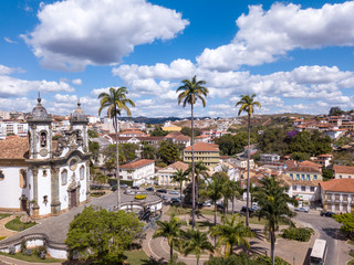 Obraz premium Drone aerial view of Sao Joao del Rei city, Minas Gerais, Brazil with church of Sao Francisco de Assis in sunny summer day. Baroque catholic heritage built with the artist Aleijadinho.