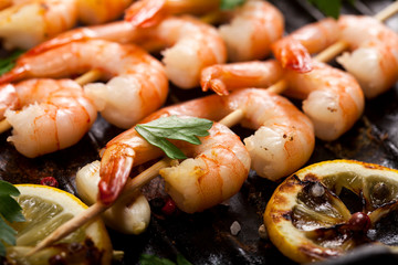 Closeup of prawns Shrimps roasted on pan with lemon, garlic and herbs.