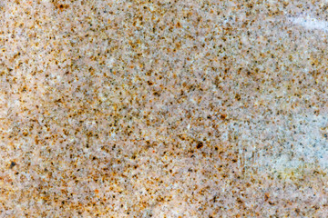 Background image of a brown, wet, marble slab.
