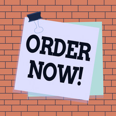 Text sign showing Order Now. Business photo text confirmed request by one party to another to buy sell Paper stuck binder clip colorful background reminder memo office supply