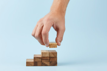 hand put wooden blocks arranging stacking for development as step stair