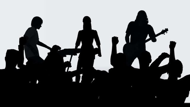Band playing to cheering crowd in silhouette