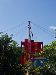 A red and yellow crane for gravel distribution