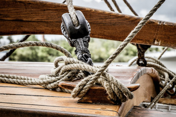 lines, pulley and rigging on the deck of a wooden tall ship
