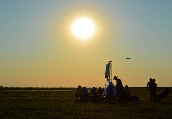 Fototapeta na wymiar Sunset, background fly , people assemble plain airplane dream