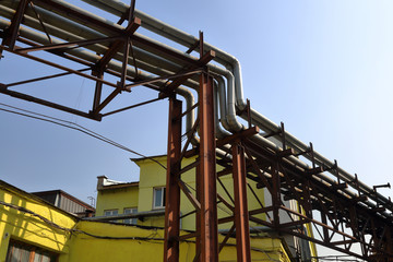 Outdoor industrial pipes of manufacturing plant on a sunny day