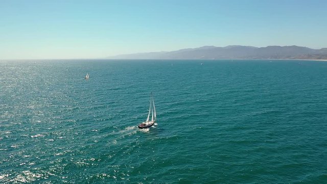 Aerial view of a yacht sailing near Santa Monica Beach in California