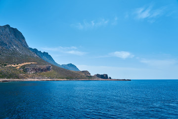 Rocky sea coast of Crete, Greece under a clear blue sky. Copy space.