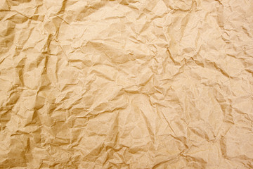 Old crumpled texture brown cardboard sheet of empty paper yellow background.