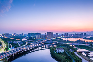 Freeway in night with cars light in modern city. 