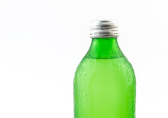 Green water or lemonade bottle with condensation drops isolated