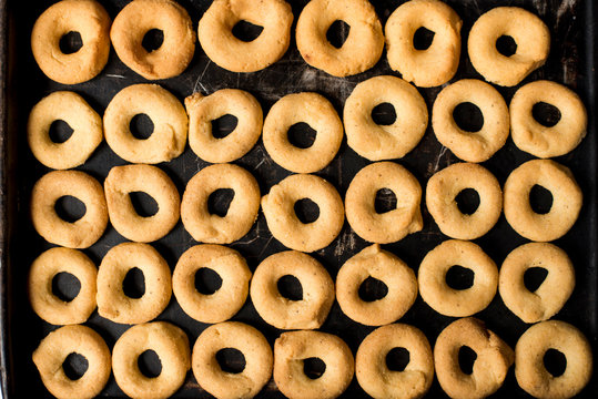 Traditional Nicaraguan rosquillas de queso / cuajada on a black tray. White background no people.
