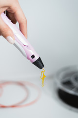 3d pen in the hands of a girl. Drawing with the 3D pen. Coils with plastic for locking a 3D printer