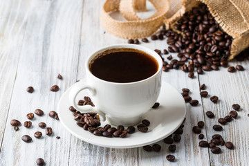 White coffee Cup on light wooden background