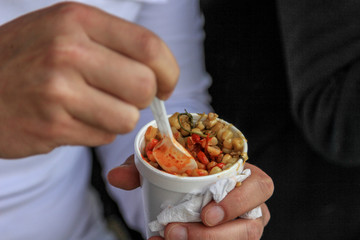 man eating green beans and corn