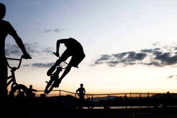 BMX cyclists training in a late afternoon in black and white