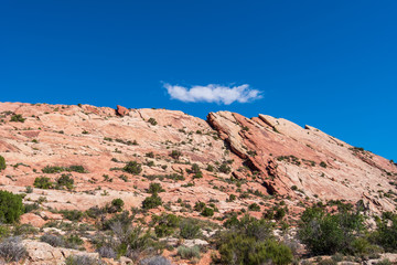 Fototapeta premium Low angle landscape of almost barren slanted red and tan stone hillside