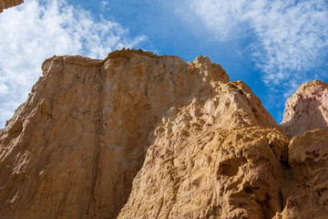 Low angle landscape of bare yellow stone formation at Interpretive Paint Mines in Colorado