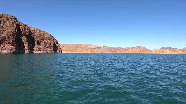 POV (point of view) of boat sailing on Lake Argyle Ord River Dam in Kimberley region, Western Australia.