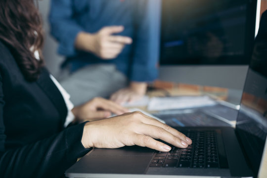 Two software developers are analyzing together about the code written into the program on the computer.