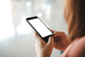 Woman are using the phone in a blank screen.
