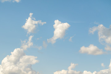 White powerfully cumulus clouds on a blue sky.