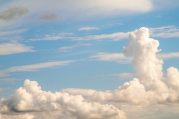 Fototapeta na wymiar White powerfully cumulus clouds on a blue sky.