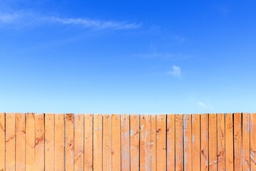 Wooden fence and blue sky, perfect background for your desktop.