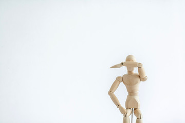 wooden mannequin with sign