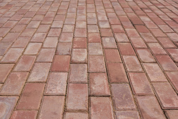Old red brick paving sidewalk low angle close-up