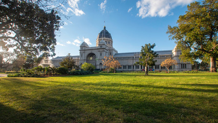 Sunset light in a historic park.   Royal Exhibition Building and Carlton Gardens. A fountain and...