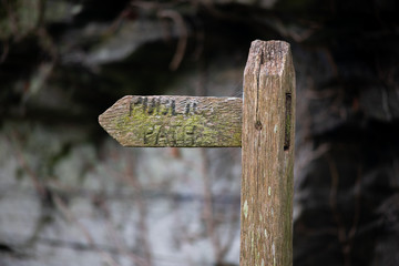 Close up view of wooden footpath sign