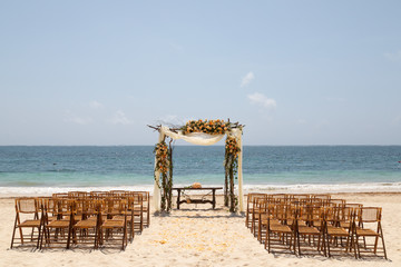 Wedding gazebo on the beach with flowers