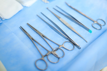 Details with surgical stainless steel grasping instruments (artery and tissue forceps, spatula, hemostats)