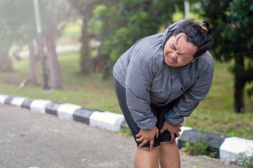 a man who is overweight is exhausted when he is trying to lose weight by running