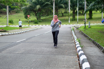portrait of muslim young woman doing exercise outdoor