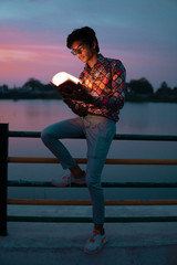 person reading a book in nature