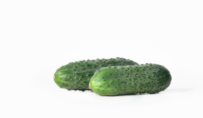 Couple of fresh cucumbers close-up on white background