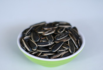 Sunflower seed snack or kuaci on plate on white background.