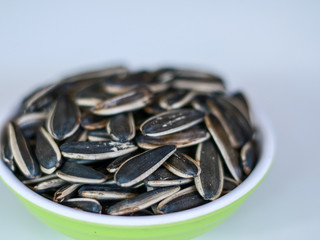 Sunflower seed snack or kuaci on plate on white background.
