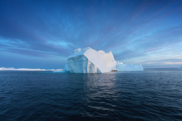 Icebergs in front of the fishing town Ilulissat in Greenland. Nature and landscapes of Greenland....
