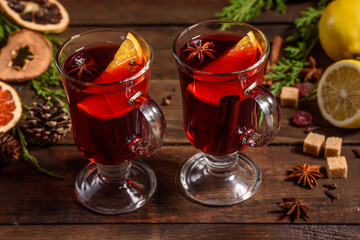 Christmas hot mulled wine with cinnamon cardamom and anise on wooden background