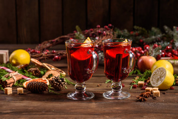 Naklejka na ściany i meble Christmas hot mulled wine with cinnamon cardamom and anise on wooden background
