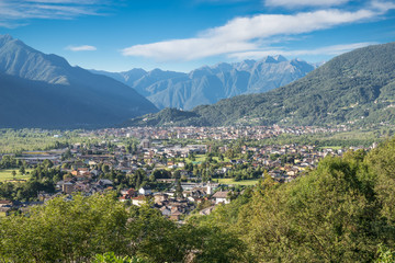 Fototapeta na wymiar Domodossola, important and ancient city in northern Italy. View towards the south. Behind the city, in the center of the photo, is the hill with the Sacred Mount Calvary of Domodossola, UNESCO site
