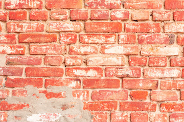 Texture of a brick wall with cracks and scratches which can be used as a background