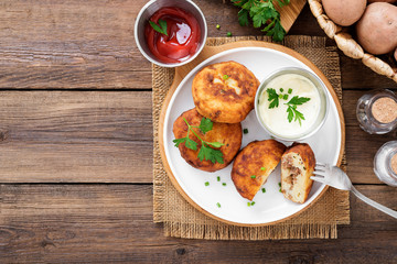 Potato patties (zrazy) Stuffed with minced meat, served with sour cream and tomato sauce.