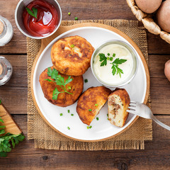 Potato patties (zrazy) Stuffed with minced meat, served with sour cream and tomato sauce.
