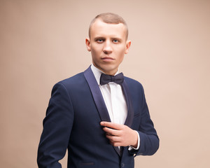 Portrait of handsome stylish man in elegant blue suit