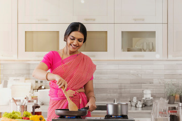 woman in saree cooking in the kitchen	