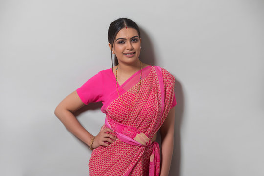 young woman in saree smiling 	